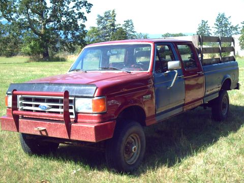 1991 Ford F-350 - This 1991 Ford F-350 pickup truck features a dual-tone paint scheme and a wooden bed rack.