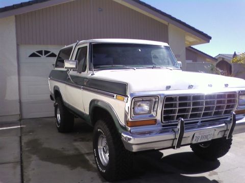 1978 Ford Bronco - This 1978 Ford Bronco is parked in a driveway in front of a house with a garage door.