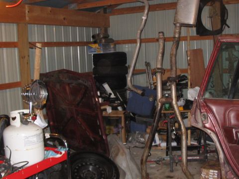 1979 Ford LTD - Parts laying around the garage. Hood, exhaust, and fuel tank are easily visible. Dig the little propane heater I got to cut the winter chil…