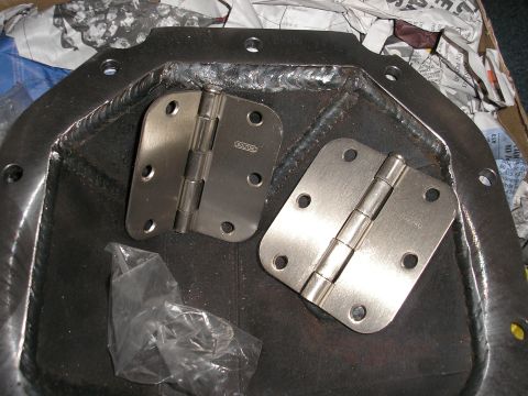 1995 Ford Bronco - New door hinges are placed on a welded metal component, possibly for a custom build.