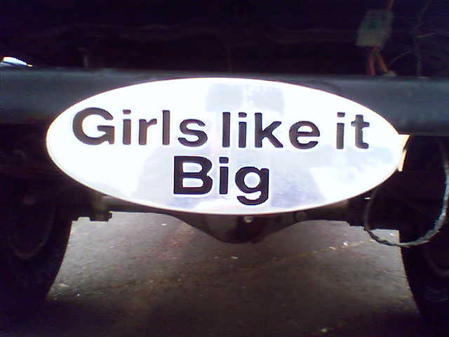 White oval 'Girls like it Big' decal on the rear of a truck above the hitch area