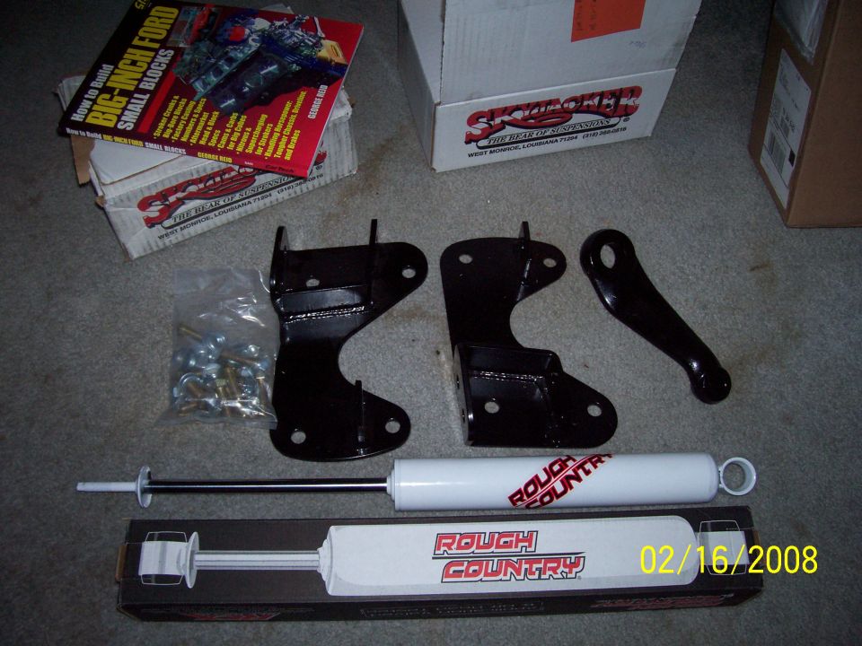 Rough Country lift kit components and 'How to Build Big-Inch Ford Small Blocks' book