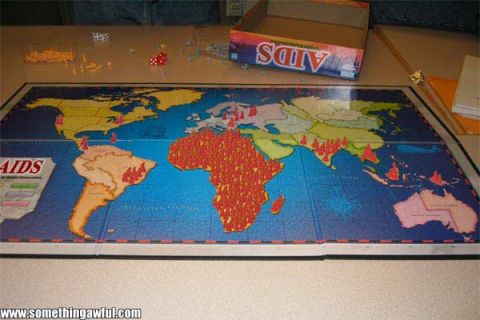 1985 Ford LTD Crown Victoria - Photo of an AIDS board game set up on a table, showing a world map board with playing pieces, not a technical document.