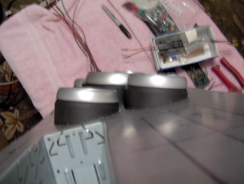 1978 Ford Bronco - A close-up view of dashboard knobs and associated wiring, with electronic components and tools scattered around.