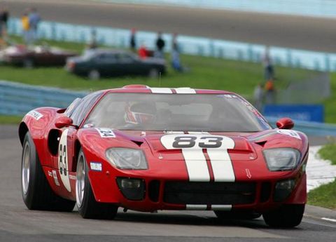 1981 Kawasaki Bayou - A red race car with white stripes and the number 83 is seen on a race track, with spectators in the background.
