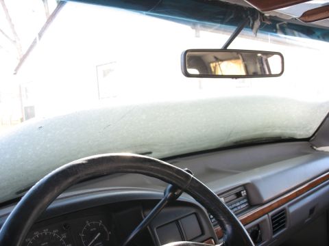 1995 Ford C-350 (Centurion Conversions) - Interior view of a vehicle's dashboard and steering wheel, with frost covering the windshield.