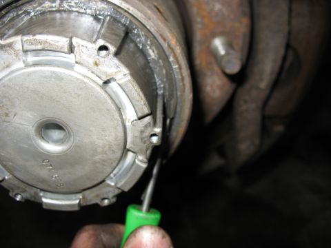 1995 Ford C-350 (Centurion Conversions) - Close-up of a vehicle hub assembly with a green tool. Part number '070 698' is visible.