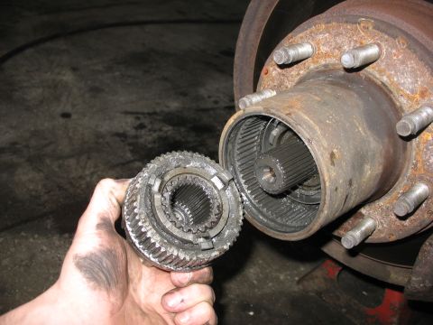1995 Ford C-350 (Centurion Conversions) - Close-up of a front axle hub assembly with the manual locking mechanism removed, revealing the splined shaft.