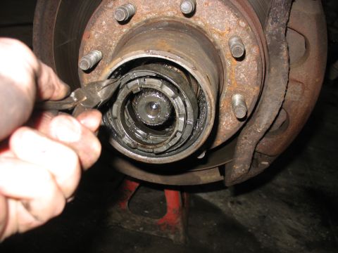 1995 Ford C-350 (Centurion Conversions) - Front wheel hub assembly being serviced, likely a manual locking hub.