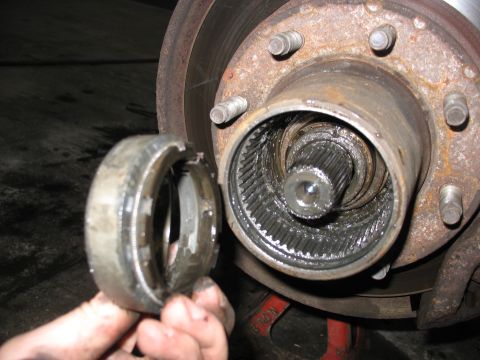 1995 Ford C-350 (Centurion Conversions) - The inner workings of a vehicle's front wheel hub assembly are exposed during maintenance.