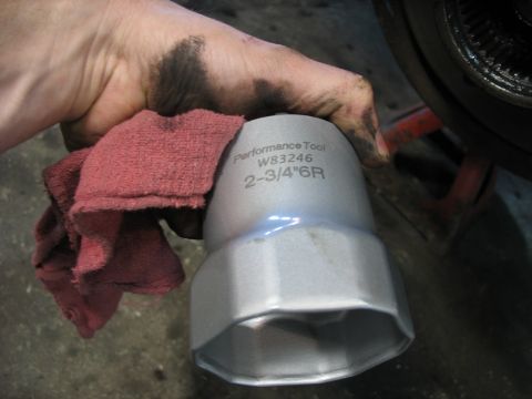 1995 Ford C-350 (Centurion Conversions) - A mechanic's greasy hand holds a 2-3/4" 6R oil filter wrench.