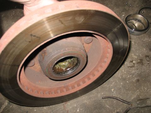 1995 Ford C-350 (Centurion Conversions) - A close-up view of a vehicle's brake rotor and hub assembly, showing the greased bearing.