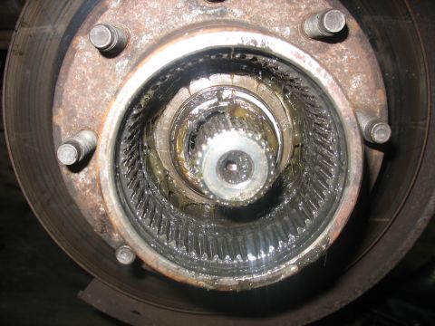 1995 Ford C-350 (Centurion Conversions) - This image shows a heavily greased and splined front wheel hub assembly, likely requiring maintenance or repair.