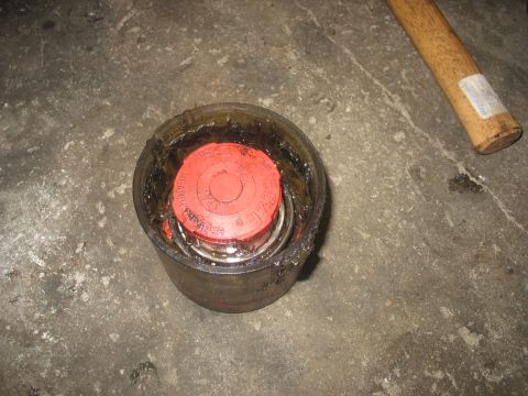1995 Ford C-350 (Centurion Conversions) - Bearing assembly with red cap, likely for a vehicle's front axle rebuild.