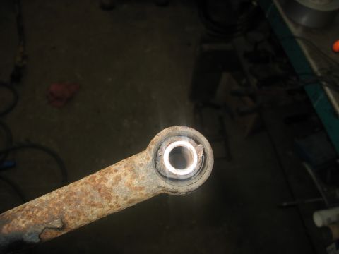 1995 Ford C-350 (Centurion Conversions) - This heavily corroded suspension part shows significant wear on its bushing, indicating a need for replacement.