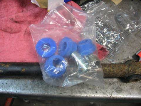 1995 Ford C-350 (Centurion Conversions) - New suspension bushings and hardware are laid out, ready for installation on a vehicle part.