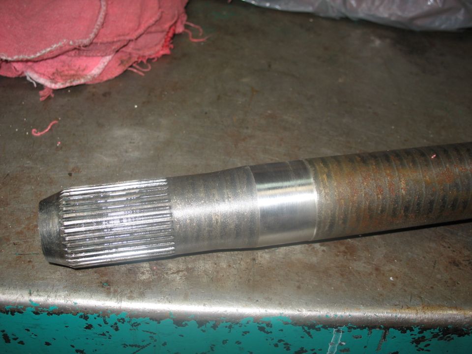 Axle shaft with splines on one end and a worn section on the shaft