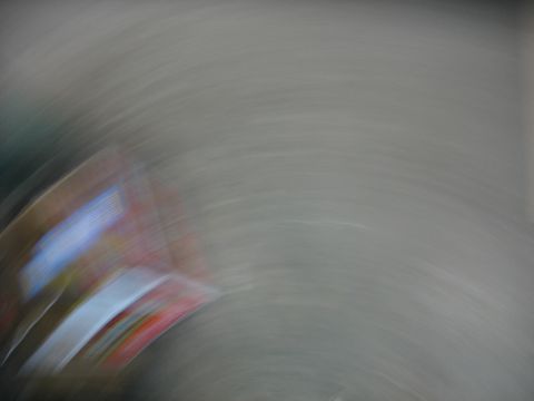 1995 Ford C-350 (Centurion Conversions) - The image shows a blurry, abstract view of a vehicle part with red, white, and blue colors, making identification difficult.