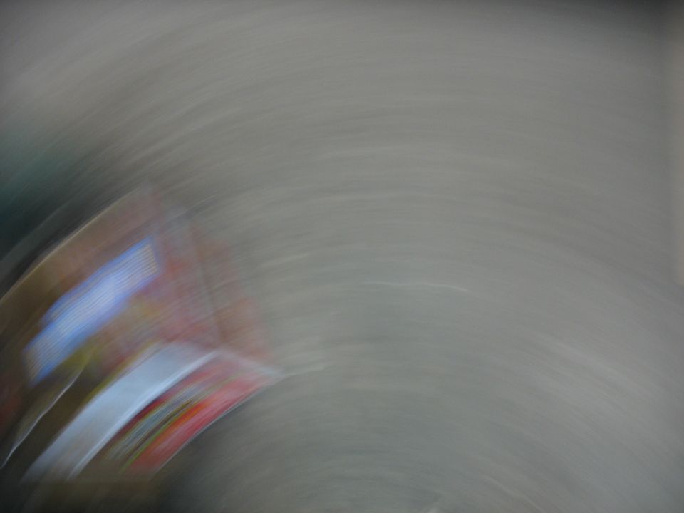 Blurry red, white, and blue part of a vehicle