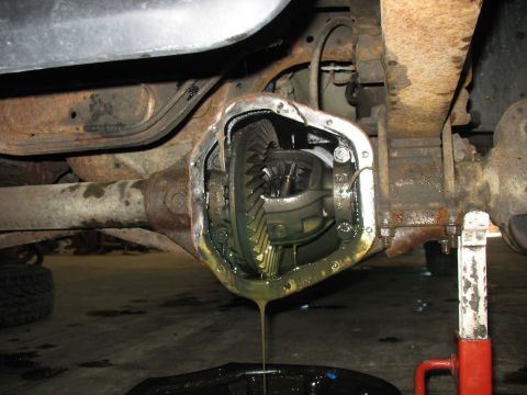 1995 Ford C-350 (Centurion Conversions) - The rear differential housing is open, revealing the internal gears and dripping oil.