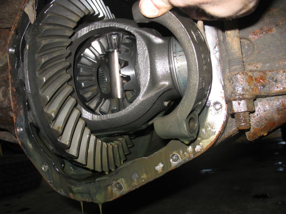 Differential gears with a ring gear and pinion gear visible, part of a vehicle's drivetrain