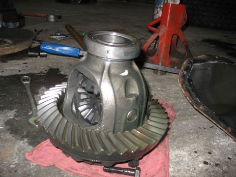 1995 Ford C-350 (Centurion Conversions) - A differential gear assembly and its ring gear are shown disassembled, resting on a red cloth with tools nearby.