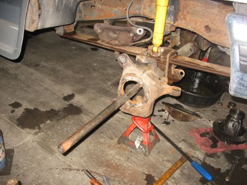 1995 Ford C-350 (Centurion Conversions) - Front axle components are disassembled and supported by jack stands, indicating a repair or rebuild process.