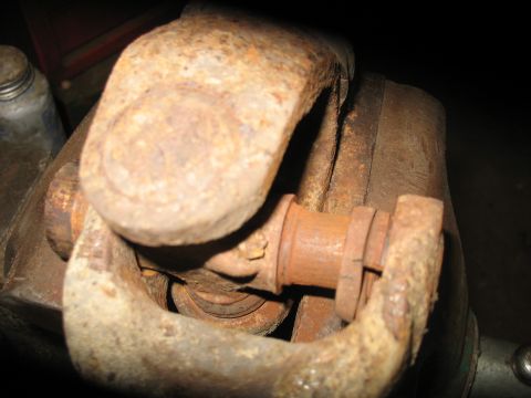 1995 Ford C-350 (Centurion Conversions) - Rusted universal joint and yoke assembly, likely a vehicle part, shown in detail.