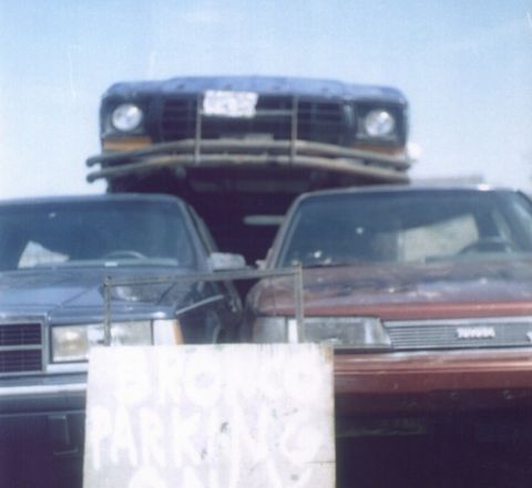 1978 Ford Bronco - A 1978 Ford Bronco is seen on a car carrier, partially obscured by other vehicles.