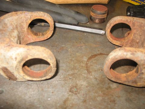 1995 Ford C-350 (Centurion Conversions) - Close-up of rusted u-joint yokes and tools, likely for a vehicle repair or rebuild.