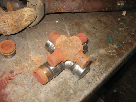 1995 Ford C-350 (Centurion Conversions) - Universal joint cross and bearing cups are shown on a workbench, alongside driveshaft components.