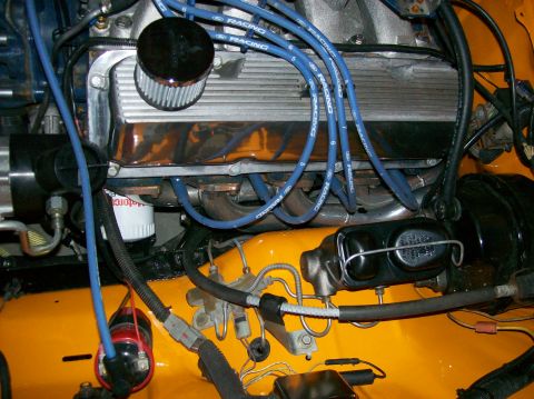1978 Ford Mustang II - Close-up of an engine bay showing various components and wiring, with a focus on the valve covers and spark plug wires.