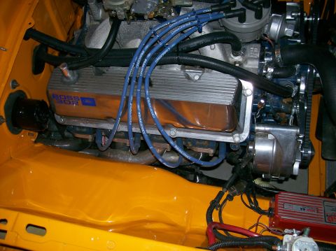 1978 Ford Mustang II - Close-up of an engine bay a BOSS 302 valve cover and blue racing spark plug wires.