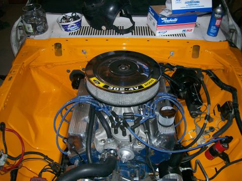 1978 Ford Mustang II - Engine bay with a Ford 302-4V Boss engine, chrome valve covers, and yellow paint.