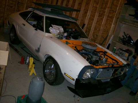 1978 Ford Mustang II - This 1978 Ford Mustang II is in a garage, likely undergoing restoration or repair.