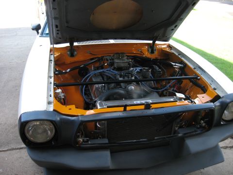 1978 Ford Mustang II - The engine bay of a 1978 Ford Mustang II shows a V8 engine with modifications.