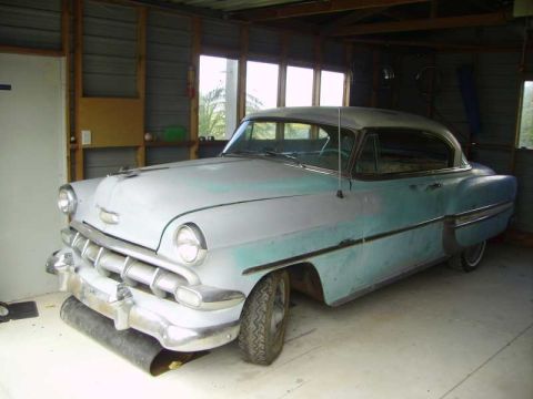1969 Lincoln Continental - A classic car sits in a garage, showing signs of a paint job in progress.