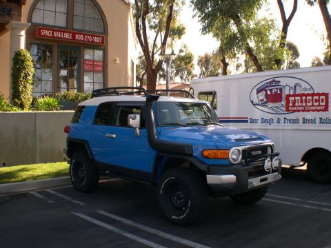 2007 Toyota FJ Cruiser - Blue 2007 Toyota FJ Cruiser with snorkel parked in a lot next to a Frisco Baking Company truck.