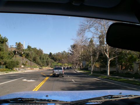 2007 Toyota FJ Cruiser - Silver SUV driving on a sunny road, identified as a 2007 Toyota FJ Cruiser.