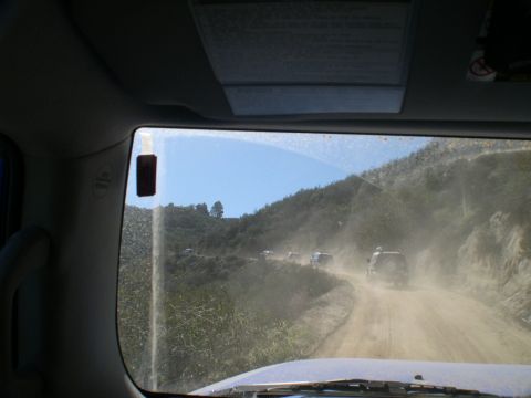2007 Toyota FJ Cruiser - A convoy of SUVs navigates a dusty mountain road.