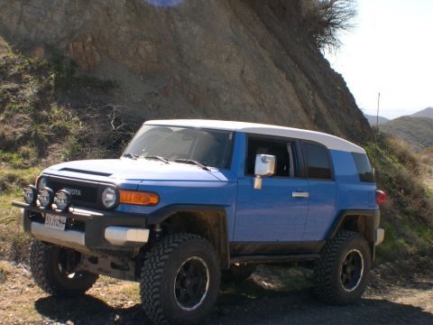 2007 Toyota FJ Cruiser - Blue 2007 Toyota FJ Cruiser on a dirt road, with a rocky hillside in the background.