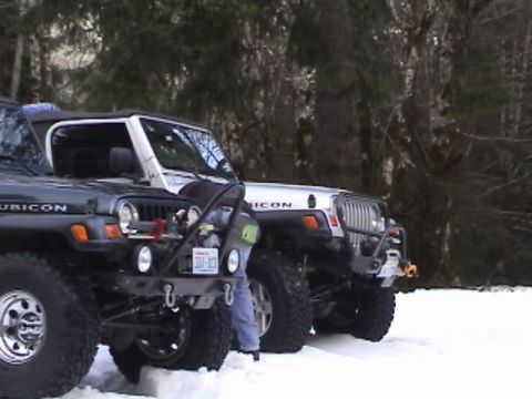 2005 Jeep Wrangler - Two Jeep Wranglers are parked in the snow, with one in the foreground and another behind it.