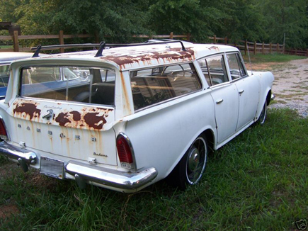 1991 Ford Bronco - This white station wagon shows extensive rust damage, particularly on its roof and rear panel.
