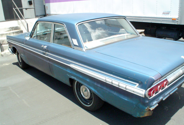 Blue 1963 sedan, rear view, showing triple taillights and chrome trim