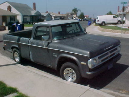 1991 Ford Bronco - This Dodge pickup truck is parked on a residential street, showing its front quarter profile.