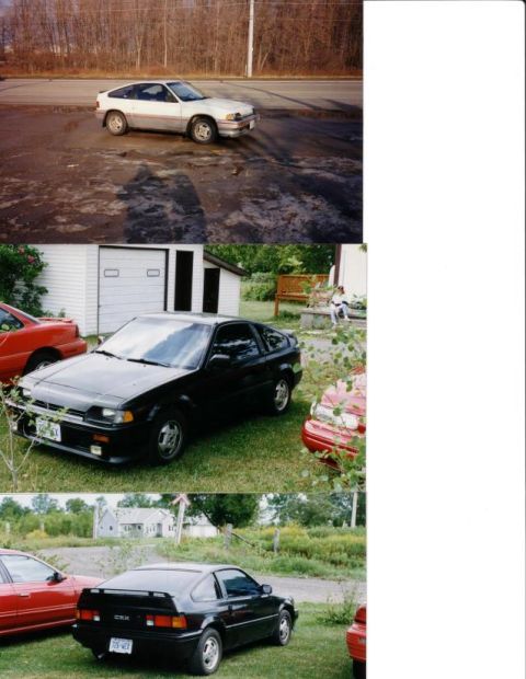 1991 Ford Bronco - This black Honda CRX is parked on a grassy area next to a red car.