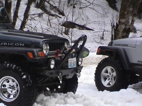 2005 Jeep Wrangler - Two Jeep Wranglers, one black Rubicon and one silver, parked in the snow.