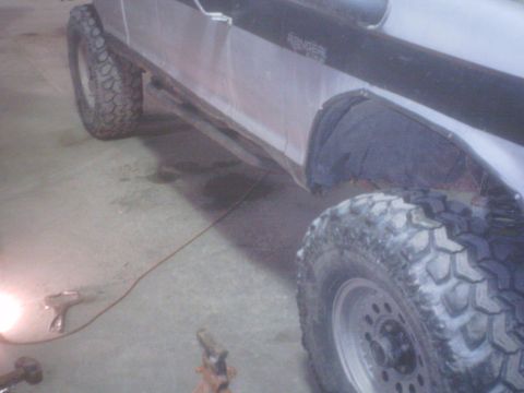 1990 Ford Ranger - This truck has large tires and fender flares, with a black tube accessory along the side.