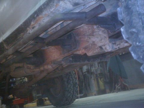 1990 Ford Ranger - Underside view shows the frame, exhaust, and tire of a truck.
