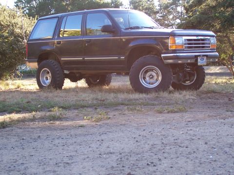 1977 Ford F-150 - This lifted Ford Explorer SUV is shown from a 3/4 front angle, parked outdoors.
